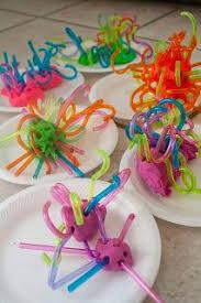 Colorful balls of Play-doh with bendable straws stuck in them