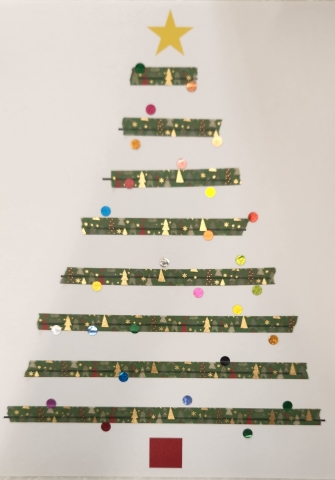 Christmas tree created with washi tape lines with small sparkly dot stickers as ornaments.