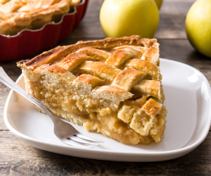 Photo of a slice of apple pie on a white plate