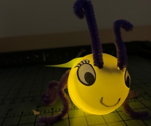 A glowing yellow lightening bug craft