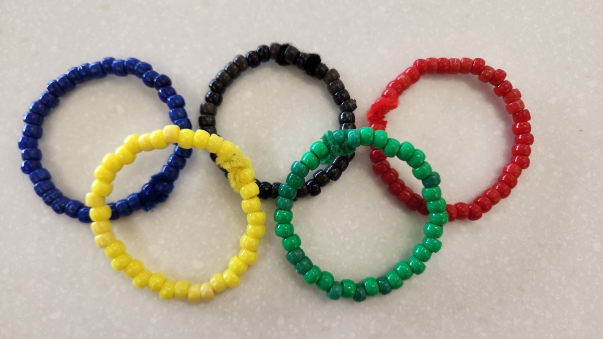 Beads on pipe cleaners in the colors of the Olympics rings