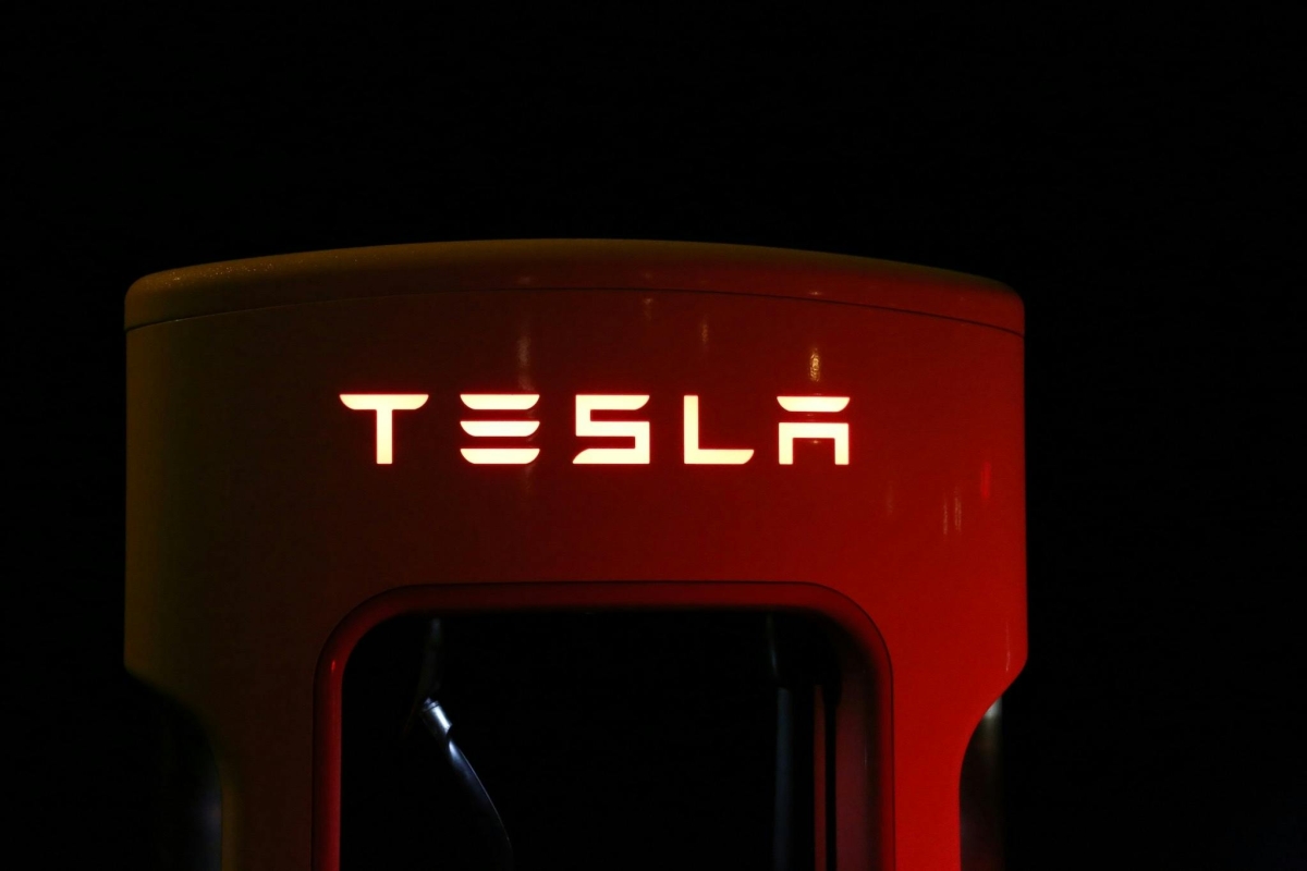 A red Tesla vehicle charging station on a black background.